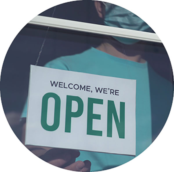 retail store door with sign stating 'we're open'